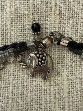 Silver wrap leather chair bracelet with elephant accent